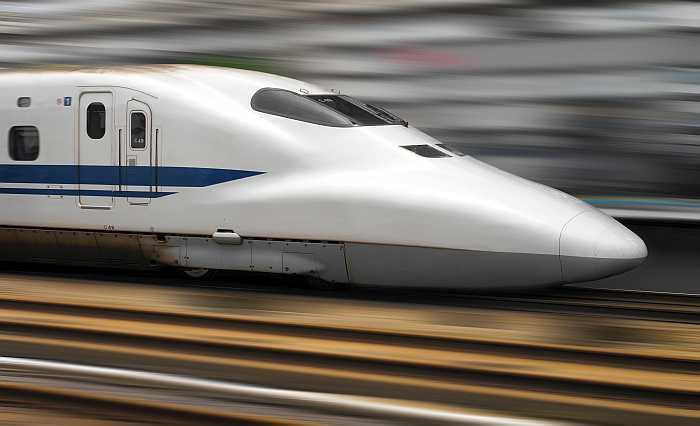 Bullet train speeding through railway station in Tokyo 