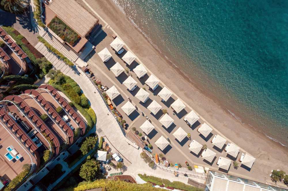 Private beach with shaded lounges and sea views at Dukley Resort