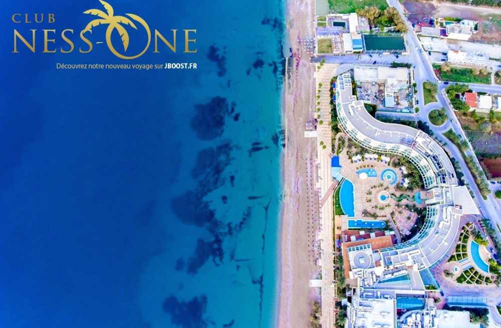 Exterior of Club Hotel Casino Loutraki with beachfront location and palm trees in Loutraki, Greece